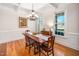 Elegant dining room with beautiful hardwood floors, crown molding, and large windows that bring in natural light at 706 Oldwyck Dr, Fuquay Varina, NC 27526