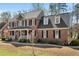 Attractive two-story brick home featuring a well-maintained lawn and traditional architectural details at 706 Oldwyck Dr, Fuquay Varina, NC 27526