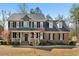 Charming two-story brick home with a welcoming front porch and manicured landscaping at 706 Oldwyck Dr, Fuquay Varina, NC 27526