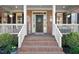 Close-up of a charming front entrance featuring a welcoming wreath and well-kept brick steps at 706 Oldwyck Dr, Fuquay Varina, NC 27526