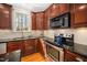 Lovely kitchen with wood cabinets, granite counters, and stainless steel appliances offers style and functionality at 706 Oldwyck Dr, Fuquay Varina, NC 27526