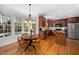 Eat-in kitchen features stainless steel appliances, wooden cabinetry, and a view overlooking the pool area at 706 Oldwyck Dr, Fuquay Varina, NC 27526