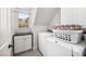 Convenient laundry room featuring modern washer and dryer, plus storage cabinet at 706 Oldwyck Dr, Fuquay Varina, NC 27526