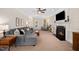 Comfortable living room with fireplace, plush seating, and warm lighting, perfect for relaxing and entertaining at 706 Oldwyck Dr, Fuquay Varina, NC 27526