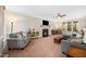 Inviting living room features a fireplace, crown molding, and large windows for plenty of natural light at 706 Oldwyck Dr, Fuquay Varina, NC 27526