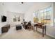 Inviting living room with two windows, a TV, a comfortable sofa, ottoman and a study desk at 706 Oldwyck Dr, Fuquay Varina, NC 27526