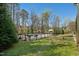 Beautiful backyard oasis with a large pool, wooden fence, and lush green landscaping at 706 Oldwyck Dr, Fuquay Varina, NC 27526