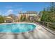 An in-ground swimming pool with a wooden deck and landscaped backyard at 706 Oldwyck Dr, Fuquay Varina, NC 27526