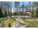 Backyard showcases a fenced pool area, lush lawn, and a paved pathway at 706 Oldwyck Dr, Fuquay Varina, NC 27526