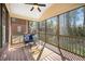 Relaxing screened porch with a ceiling fan, wicker furniture, and scenic backyard view at 706 Oldwyck Dr, Fuquay Varina, NC 27526