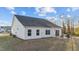 Exterior view features a white siding, dark roof, and a small patio at 75 Red Crabapple Ct, Clayton, NC 27520