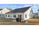 Cozy patio with string lights, grill, and a small garden bed at 75 Red Crabapple Ct, Clayton, NC 27520