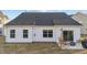 Exterior view features a white siding, dark roof, and a cozy patio at 75 Red Crabapple Ct, Clayton, NC 27520