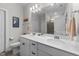 Bright bathroom with double sinks, white cabinets, large mirror, and a separate shower room at 75 Red Crabapple Ct, Clayton, NC 27520