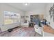 Bright bedroom with a large window, comfortable seating area, and a full bookcase at 75 Red Crabapple Ct, Clayton, NC 27520