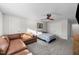 Spacious bedroom featuring soft carpet, modern fan, and a comfortable sitting area at 75 Red Crabapple Ct, Clayton, NC 27520