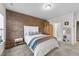 Bedroom with brick accent wall, a white bed frame, and stylish decor, creating a comfortable retreat at 75 Red Crabapple Ct, Clayton, NC 27520
