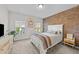 Cozy bedroom features a textured brick wall, two windows with natural light, and neutral decor at 75 Red Crabapple Ct, Clayton, NC 27520
