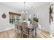 Bright dining room with lots of natural light, hardwood floors, and sliding glass door access to yard at 75 Red Crabapple Ct, Clayton, NC 27520