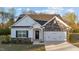 Charming single-Gathering home featuring stone accents, a black front door with wreath, and a well-maintained lawn at 75 Red Crabapple Ct, Clayton, NC 27520