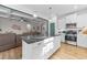 Kitchen features a central island with quartz countertops and stainless steel appliances at 75 Red Crabapple Ct, Clayton, NC 27520