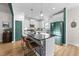 Well-lit kitchen features a central island with bar seating, white cabinetry, and stainless appliances at 75 Red Crabapple Ct, Clayton, NC 27520