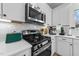 Kitchen boasting sleek stainless steel appliances, crisp white cabinets, and modern fixtures at 75 Red Crabapple Ct, Clayton, NC 27520