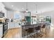 Bright kitchen with stainless steel appliances, statement island, and stylish breakfast bar seating at 75 Red Crabapple Ct, Clayton, NC 27520
