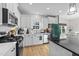Well-appointed kitchen showcasing stainless steel appliances, white cabinets, and an island with quartz countertops at 75 Red Crabapple Ct, Clayton, NC 27520