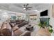 Spacious living room features a coffered ceiling, fireplace, and a leather sectional couch with an open concept to the kitchen at 75 Red Crabapple Ct, Clayton, NC 27520