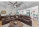 Inviting living room features a large sectional sofa and easy access to an open kitchen area and dining area at 75 Red Crabapple Ct, Clayton, NC 27520