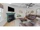 Cozy living room features a fireplace, coffered ceiling, and comfortable leather seating at 75 Red Crabapple Ct, Clayton, NC 27520
