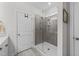 Modern shower room features tiled walls, glass door, and built-in shelves at 75 Red Crabapple Ct, Clayton, NC 27520