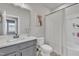 Bright bathroom with gray cabinets, white countertops, and a shower-tub combination with curtain at 818 Lilyquist Way, Wake Forest, NC 27587