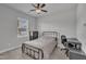 Neutral bedroom featuring a window, a bed, a desk, and a dresser for a comfortable living space at 818 Lilyquist Way, Wake Forest, NC 27587