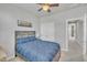 Cozy bedroom featuring neutral walls, carpet flooring, and a blue upholstered bed at 818 Lilyquist Way, Wake Forest, NC 27587