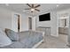 Bedroom with a bed, dresser, ceiling fan, and a doorway that leads into the bathroom at 818 Lilyquist Way, Wake Forest, NC 27587
