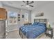 Comfortable bedroom with a blue quilted bedspread, neutral walls, and ample natural light at 818 Lilyquist Way, Wake Forest, NC 27587