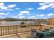Wooden deck with chairs overlooking a serene lake and neighborhood at 818 Lilyquist Way, Wake Forest, NC 27587