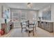 Cozy dining area featuring natural light, wooden table and chairs, and decorative rug at 818 Lilyquist Way, Wake Forest, NC 27587