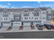 Charming townhome exteriors showcasing modern design with attached garages and well-manicured front yards at 818 Lilyquist Way, Wake Forest, NC 27587