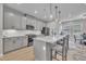 Stylish kitchen with gray cabinets, stainless steel appliances, and a large island with seating at 818 Lilyquist Way, Wake Forest, NC 27587