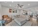 Spacious living room with hardwood floors, a plush sectional, and an open concept to the kitchen at 818 Lilyquist Way, Wake Forest, NC 27587