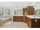 Bright bathroom featuring double vanity, soaking tub, and glass enclosed shower at 8215 Cushing St, Raleigh, NC 27613