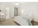 Bedroom featuring white walls, plush carpeting, ceiling fan, and ensuite bathroom at 8215 Cushing St, Raleigh, NC 27613