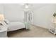 Bright bedroom features white walls, ceiling fan, and a large window for natural light at 8215 Cushing St, Raleigh, NC 27613