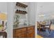 Convenient butler pantry area with granite countertop, custom cabinets and wine storage at 8215 Cushing St, Raleigh, NC 27613
