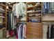 Organized walk-in closet featuring shelves and hanging rods for clothing storage at 8215 Cushing St, Raleigh, NC 27613