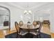 Bright dining area featuring stylish lighting, hardwood flooring, and comfortable seating at 8215 Cushing St, Raleigh, NC 27613