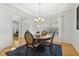 Dining room with modern chandelier, hardwood floors, and lots of natural light at 8215 Cushing St, Raleigh, NC 27613